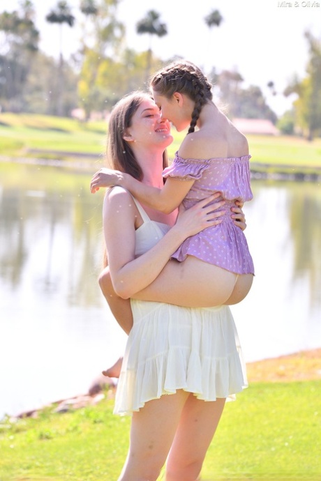 Tall and short lesbians Mira & Olivia Madison get totally naked outdoors