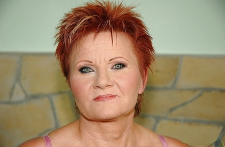 Redhead granny with tiny tits shows her shaved cunt and her hot ass