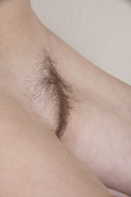 Lusty Lilianna stands on a chair to strip & spreads her hairy pussy on a table