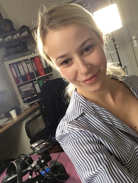 Sweet amateur blonde Jenny teases with her tiny tits in her bedroom