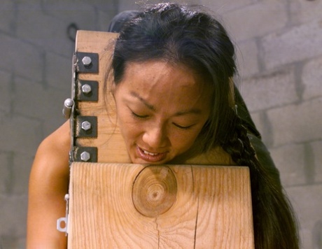 Naked brunette in bondage Kelana gets a flogging during a submission training