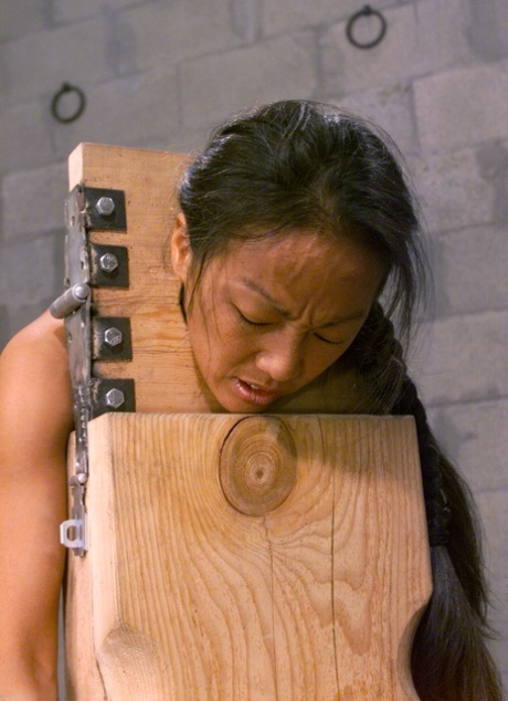 Naked brunette in bondage Kelana gets a flogging during a submission training